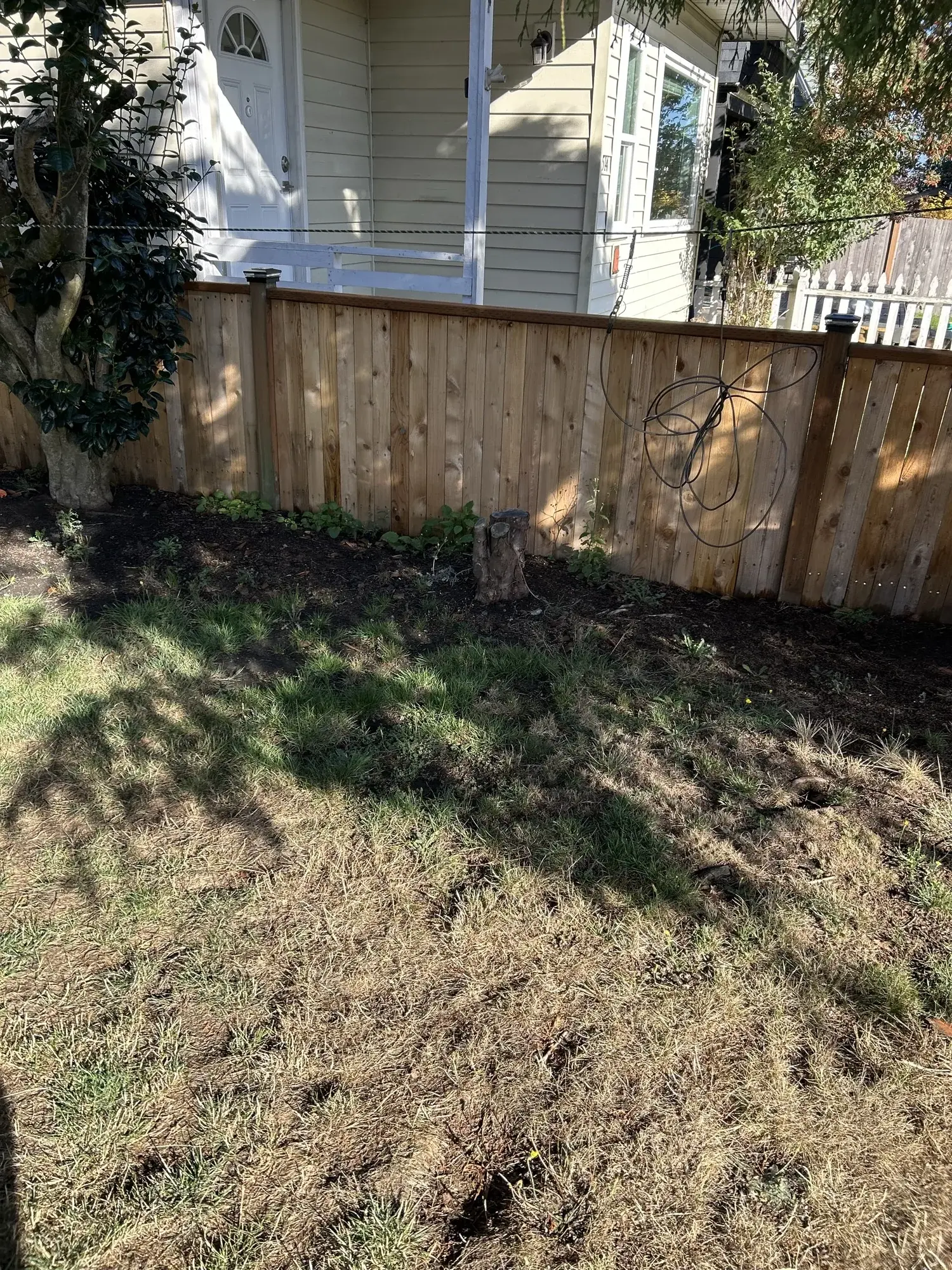 Cedar privacy fence behind an older Everett home