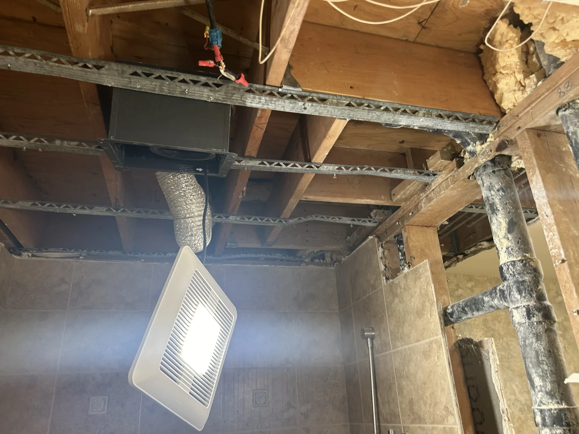 Interior ceiling opened up with HVAC duct and rough-in exposed during a remodel